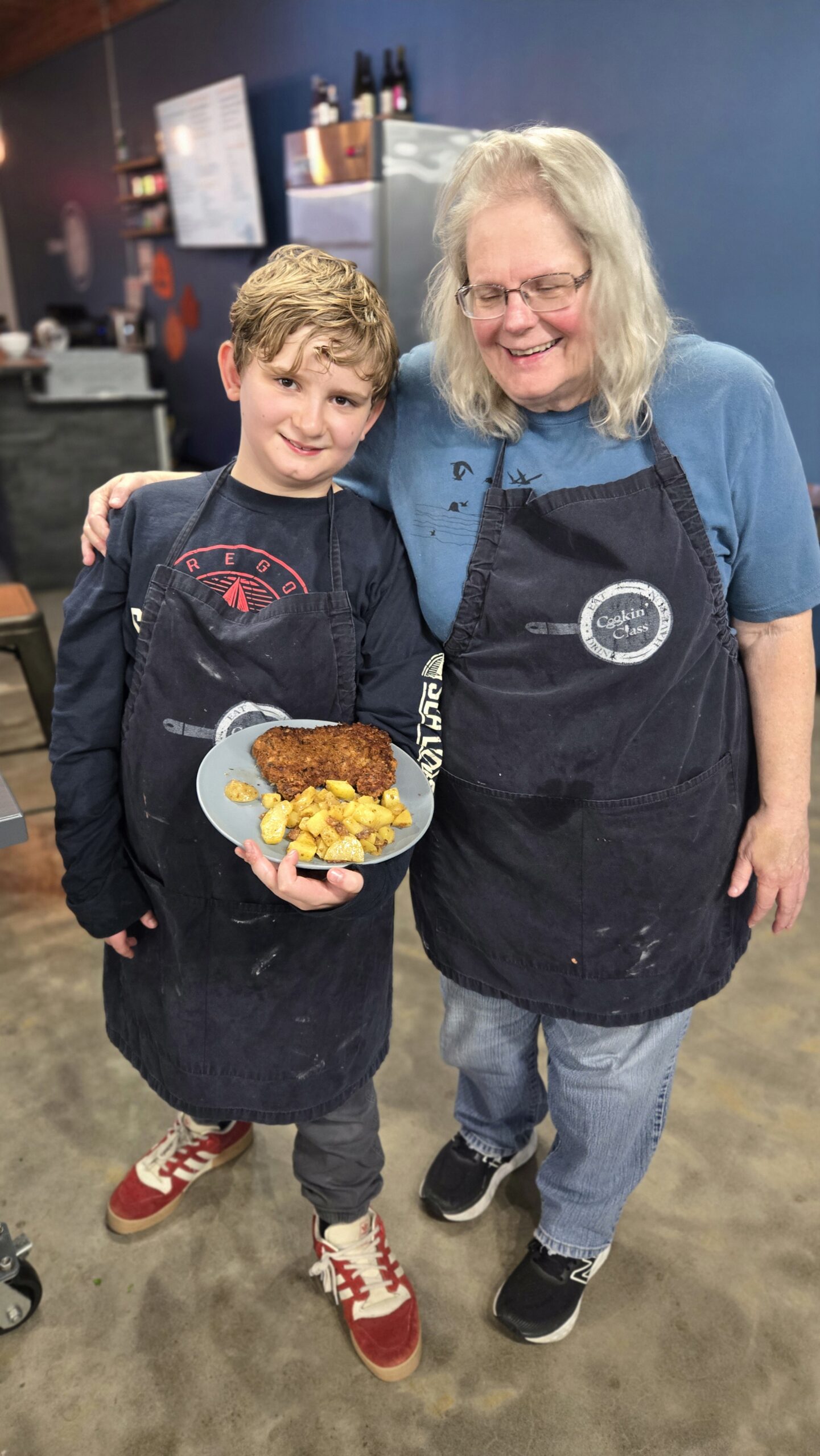 Grandmother at cooking class with grandson